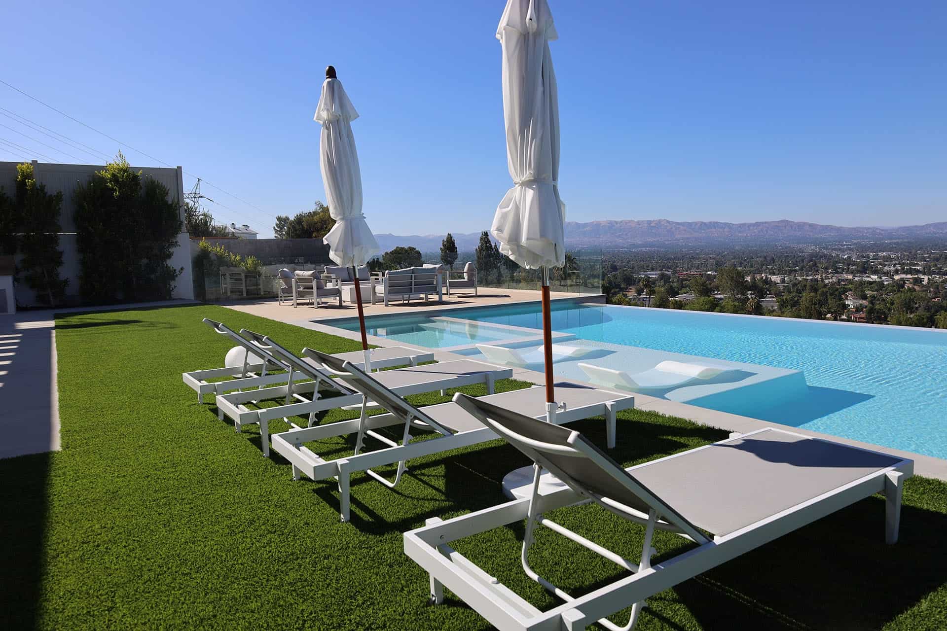 Blog hero photo for "Elevating Luxury Landscapes With Custom Pool Waterfall Design" — relevant completed pool/backyard project